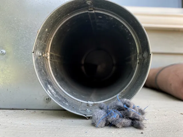Wesley Chapel Dryer Vent Cleaning technician using specialized equipment to clear severe dryer vent blockage in Wesley Chapel